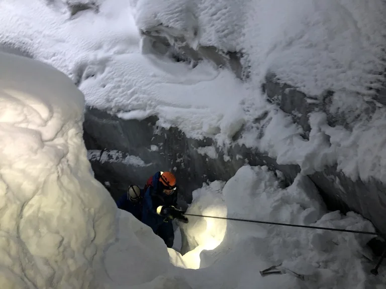 スヴァ―ルバル諸島の氷の洞窟の中を探検する人たち