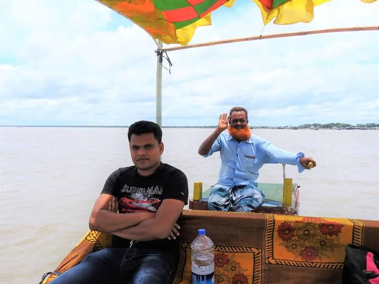 バングラデシュのシュンドルボン国立公園へ向かう観光ボートの船長と観光客