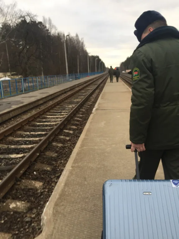 ベラルーシ国境の駅バシュタンでスーツケースを運んでくれる軍人