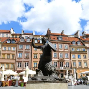 ワルシャワ旧市街（Warsaw Old Town）の市場広場に立つワルシャワの人魚像（Mermaid of Warsaw）とカラフルなタウンハウス