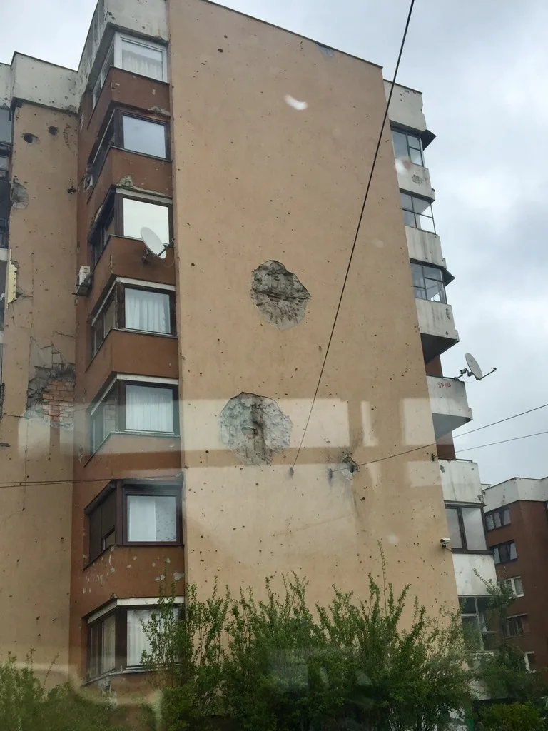 壁に大きな砲弾を受けた跡が残る建物